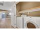Laundry area complete with washer, dryer and shelving above, located off the kitchen at 4685 Apulia Dr # 202, North Las Vegas, NV 89084
