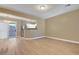 Open-concept living room features hardwood floors, neutral walls, and slider to balcony at 4685 Apulia Dr # 202, North Las Vegas, NV 89084