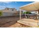 Large backyard with covered patio, BBQ grill, block fence, and low maintenance landscaping at 5019 Cactus Mesa Way, North Las Vegas, NV 89031