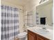 Bright bathroom featuring a vanity with storage, a toilet, and a shower-tub with updated fixtures at 5019 Cactus Mesa Way, North Las Vegas, NV 89031