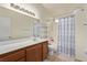 Clean bathroom with a full vanity and a shower-tub combination with a patterned shower curtain at 5019 Cactus Mesa Way, North Las Vegas, NV 89031