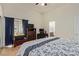 Inviting bedroom with vaulted ceilings, a dresser and desk, and a window with privacy drapes at 5019 Cactus Mesa Way, North Las Vegas, NV 89031
