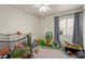 Bright room with plush carpet, a variety of toys, and a window with curtains at 5019 Cactus Mesa Way, North Las Vegas, NV 89031