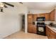 Well-lit kitchen featuring wooden cabinets, black appliances, and neutral walls at 5019 Cactus Mesa Way, North Las Vegas, NV 89031