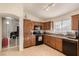 Bright kitchen featuring tile flooring, wooden cabinets, and modern appliances at 5019 Cactus Mesa Way, North Las Vegas, NV 89031