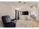 Open living room featuring TV, comfortable furniture, tile floors, and accessories at 5019 Cactus Mesa Way, North Las Vegas, NV 89031