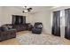 Spacious living room with tile floors, comfortable seating, and large windows at 5019 Cactus Mesa Way, North Las Vegas, NV 89031