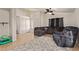 Spacious living room features neutral paint, ceiling fan, and tile flooring at 5019 Cactus Mesa Way, North Las Vegas, NV 89031
