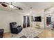 Cozy living room featuring ceiling fan, plush seating, and bright natural light at 5019 Cactus Mesa Way, North Las Vegas, NV 89031