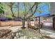 The back yard features a mature shade tree and a swing near the covered outdoor kitchen at 5049 Hibbetts Ct, Las Vegas, NV 89103