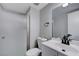 Clean bathroom featuring a shower with textured glass door, white fixtures, and modern faucet at 5049 Hibbetts Ct, Las Vegas, NV 89103