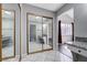A bathroom vanity with a granite countertop and a large gold framed mirrored closet with bedroom and bath access at 5049 Hibbetts Ct, Las Vegas, NV 89103