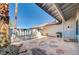 Home exterior with desert landscaping, a tiled patio and tall, stately palm trees at 5049 Hibbetts Ct, Las Vegas, NV 89103