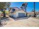 Charming two-story home with a well-maintained front yard and a two car garage at 5049 Hibbetts Ct, Las Vegas, NV 89103