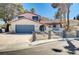 Charming two-story home with a well-maintained front yard and a two car garage at 5049 Hibbetts Ct, Las Vegas, NV 89103