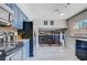 Updated kitchen with stainless steel appliances, granite counters and blue cabinets at 5049 Hibbetts Ct, Las Vegas, NV 89103