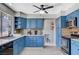 Stylish kitchen featuring blue cabinets, granite countertops, and modern appliances at 5049 Hibbetts Ct, Las Vegas, NV 89103
