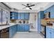 Updated kitchen featuring blue cabinets, granite countertops, and stainless steel appliances at 5049 Hibbetts Ct, Las Vegas, NV 89103