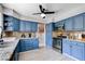 Charming kitchen featuring blue cabinets, granite countertops, and stainless steel appliances at 5049 Hibbetts Ct, Las Vegas, NV 89103