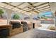 Covered patio with an outdoor kitchen including a built-in BBQ and prep area at 5049 Hibbetts Ct, Las Vegas, NV 89103