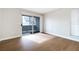 Bedroom with wood floors, a sliding door, and a large window that allows for ample natural light at 5130 Mandalay Springs Dr # 102, Las Vegas, NV 89120