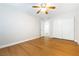 Bright bedroom featuring light wood floors, ceiling fan, and a closet with sliding doors at 5130 Mandalay Springs Dr # 102, Las Vegas, NV 89120