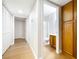 Hallway showcasing a built-in cabinet, closet, and bathroom leading to more living space at 5130 Mandalay Springs Dr # 102, Las Vegas, NV 89120