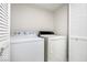 Bright laundry room with white washer, dryer, and adjacent built-in storage at 5130 Mandalay Springs Dr # 102, Las Vegas, NV 89120
