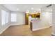 Spacious living area with wood flooring, neutral walls, and an open kitchen at 5130 Mandalay Springs Dr # 102, Las Vegas, NV 89120