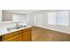 Partially captured kitchen featuring stainless sink, wood cabinetry, and neutral wall paint at 5130 Mandalay Springs Dr # 102, Las Vegas, NV 89120