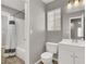 Neutral toned bathroom boasts a shower/tub combo, window, and modern fixtures at 537 Inness Ave, Henderson, NV 89011