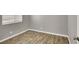 Bedroom featuring laminate flooring, window with blinds, and neutral wall paint at 537 Inness Ave, Henderson, NV 89011