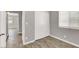 Bedroom featuring laminate flooring, a window with blinds, and sliding closet doors at 537 Inness Ave, Henderson, NV 89011