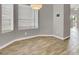 Corner dining area with wood floors, neutral walls, bright lighting, and large windows at 537 Inness Ave, Henderson, NV 89011