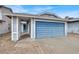 Home exterior showing a blue garage door, covered entryway, and street number at 537 Inness Ave, Henderson, NV 89011