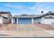 Exterior of the home featuring a blue garage door and well-kept landscaping at 537 Inness Ave, Henderson, NV 89011