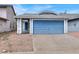 The home features a blue garage door and complementary blue front door at 537 Inness Ave, Henderson, NV 89011