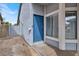 Exterior view of the front entrance featuring a blue front door and nearby windows at 537 Inness Ave, Henderson, NV 89011