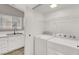 Bright laundry room with white cabinets, sink, and a modern washer and dryer at 537 Inness Ave, Henderson, NV 89011
