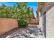 Private backyard patio area features brick pavers, a privacy wall, and lush greenery at 5614 Bishop Flowers St, Las Vegas, NV 89130