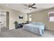 Spacious bedroom with large window, ceiling fan, blue patterned bedspread, and decor at 5614 Bishop Flowers St, Las Vegas, NV 89130