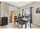Cozy dining room features tile floors, a modern light fixture, and sliding glass doors that lead to the backyard patio at 5614 Bishop Flowers St, Las Vegas, NV 89130