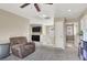 A cozy loft area with carpet, chair, staircase and cabinets at 5614 Bishop Flowers St, Las Vegas, NV 89130