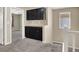A carpeted loft with dark cabinets, a window, and a doorway to another room at 5614 Bishop Flowers St, Las Vegas, NV 89130