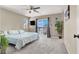 Bright main bedroom with balcony access, a ceiling fan, and neutral carpeting at 5614 Bishop Flowers St, Las Vegas, NV 89130