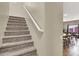 Carpeted staircase with white handrail, leading to the upper level of the home at 5614 Bishop Flowers St, Las Vegas, NV 89130
