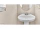 Bright powder room featuring a pedestal sink and neutral wall color at 5671 Camilla Cellars Ct, Las Vegas, NV 89141