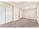 Bright bedroom boasts neutral carpet, a closet with double doors, and neutral paint at 5671 Camilla Cellars Ct, Las Vegas, NV 89141