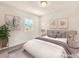 Cozy bedroom featuring soft lighting, carpet, neutral paint, and decor including artwork and a plant at 5671 Camilla Cellars Ct, Las Vegas, NV 89141