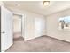 Bedroom showcasing neutral carpet, a closet with double doors, and an open doorway to another room at 5671 Camilla Cellars Ct, Las Vegas, NV 89141